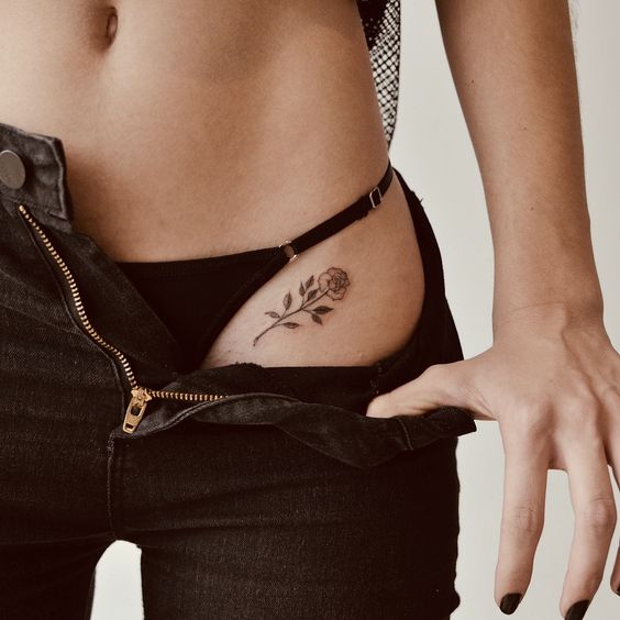 Super sexy black rose tattoo on the hip