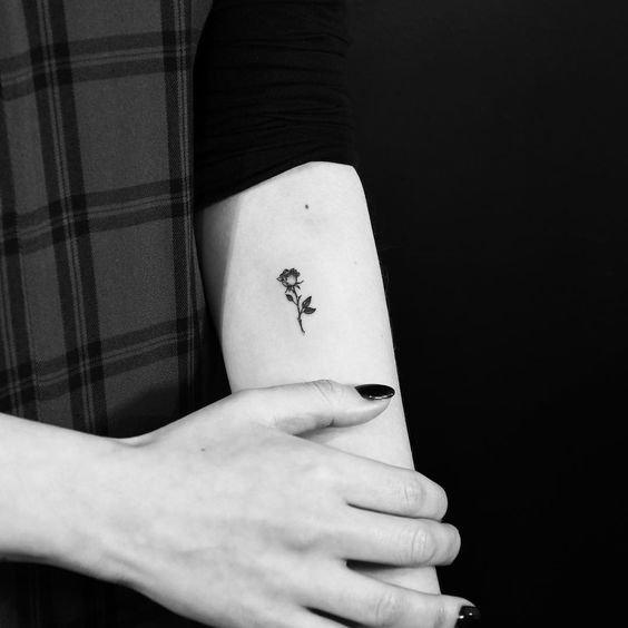 Tiny Black Rose Tattoo On inner forearm