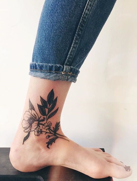 Black flower tattoo on the leg