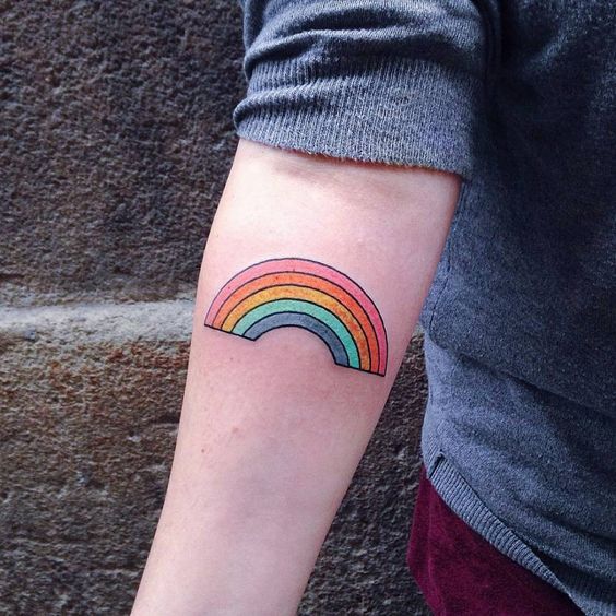 A full rainbow equality gay pride tattoo on the right inner arm
