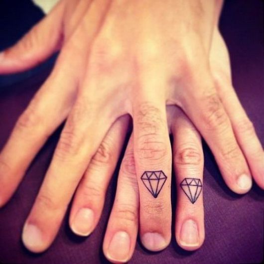 Couple diamond tattoo on a finger