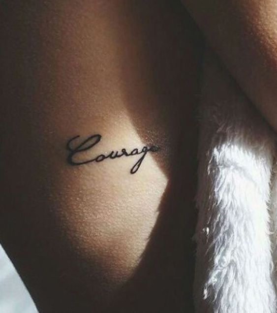 Courage tattoo on the rib