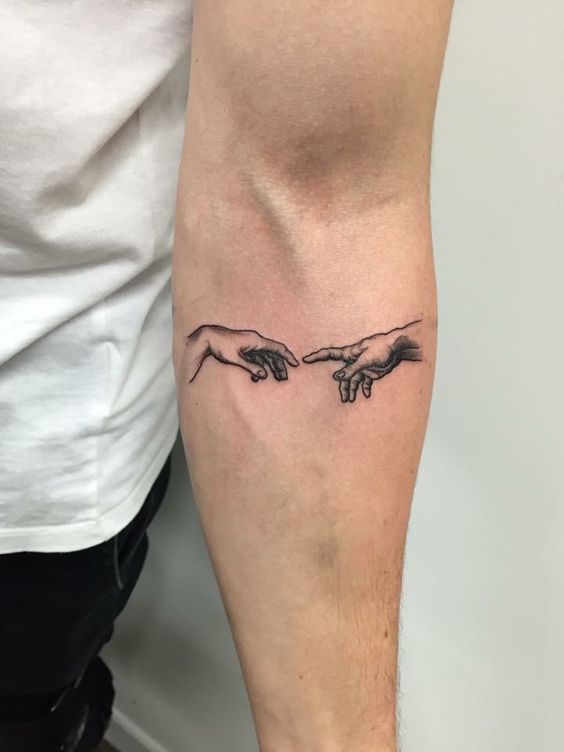 Creation of Adam tattoo on the arm