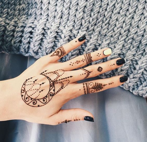 Crescent moon henna tattoo on the hand