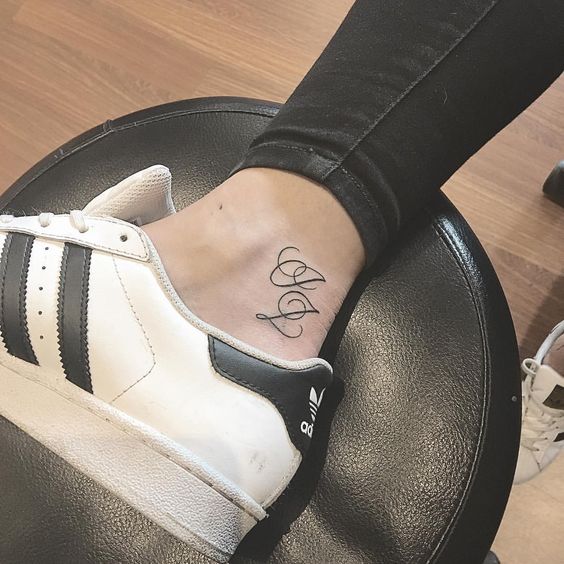 Double J initials tattoo on an ankle
