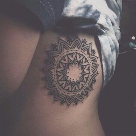 Gorgeous mandala tattoo on the ribcage