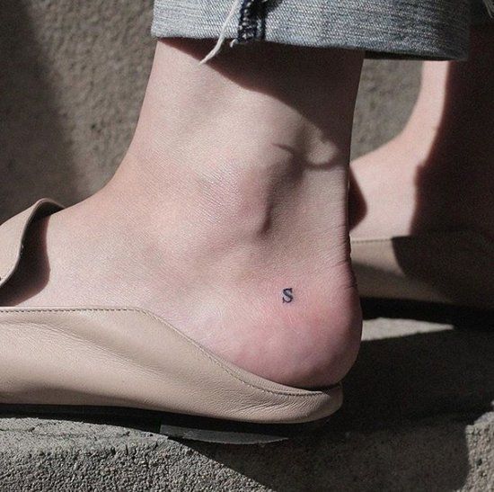 Initial letter tattoo on an ankle
