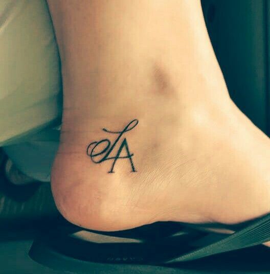 Kids initials tattoo on an ankle