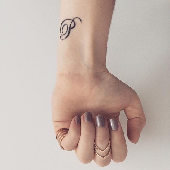 Letter P initial tattoo on a wrist