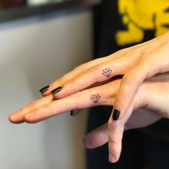 Matching diamond tattoos on fingers by Jay Shin