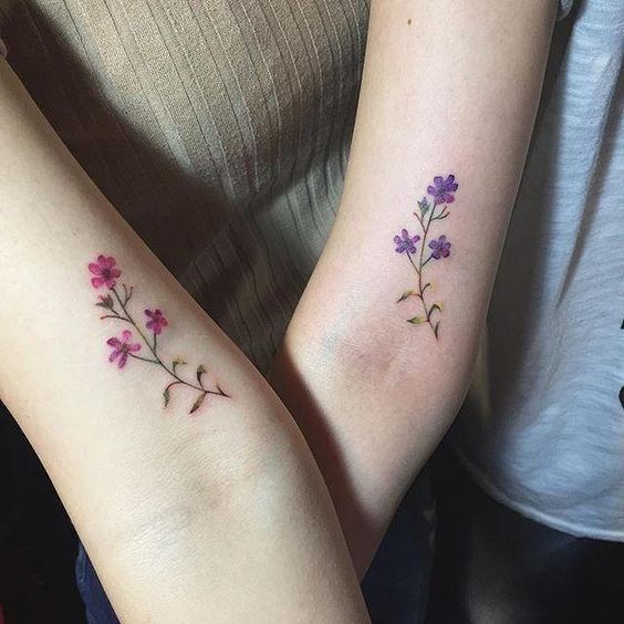 Matching flower tattoos on arms