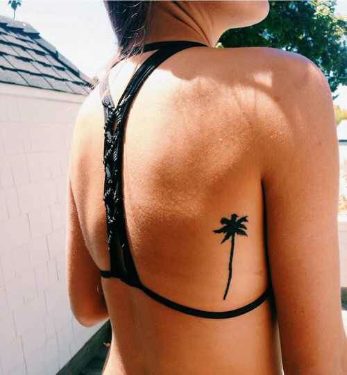 Palm tree tattoo on the right ribcage