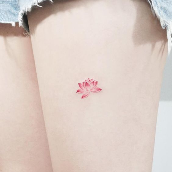 Pink lotus flower tattoo on thigh