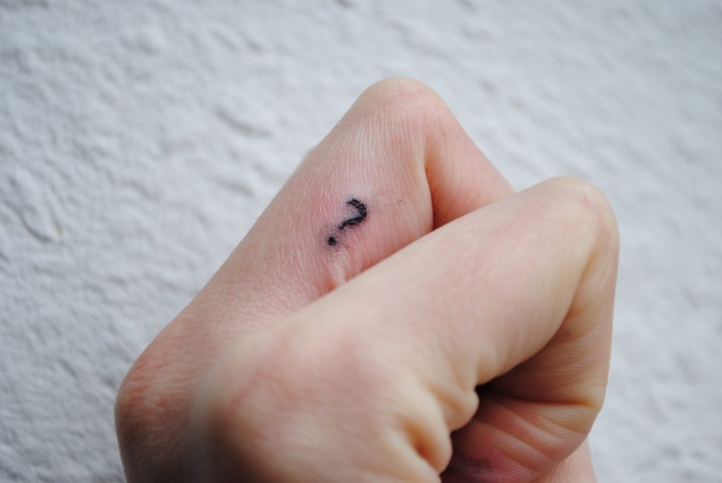 Question mark tattoo on a finger