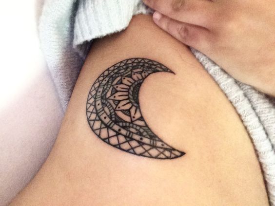 Small crescent moon tattoo on the rib