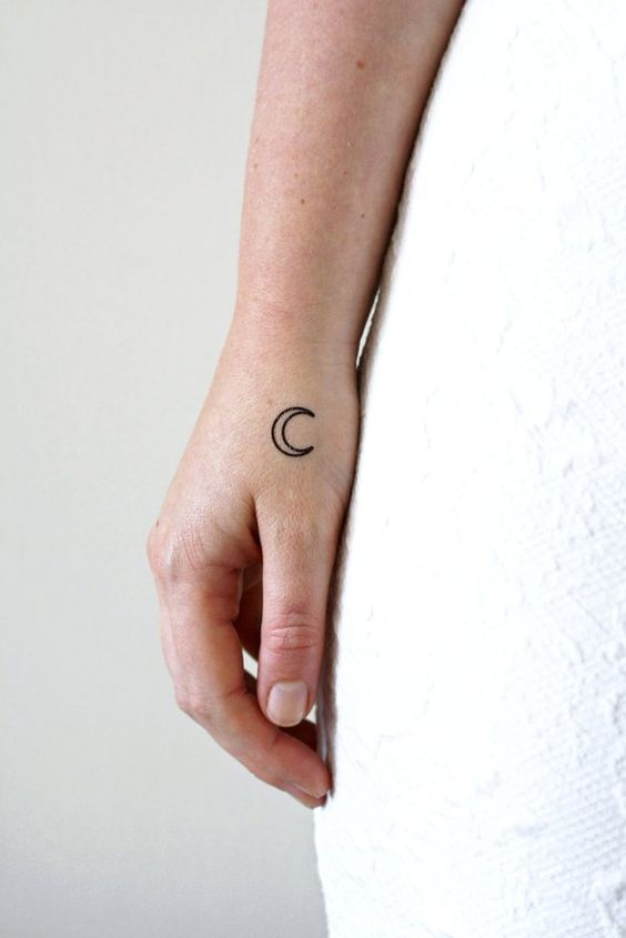 Small moon tattoo on the right hand for women