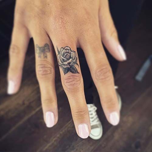 Small rose tattoo on a finger