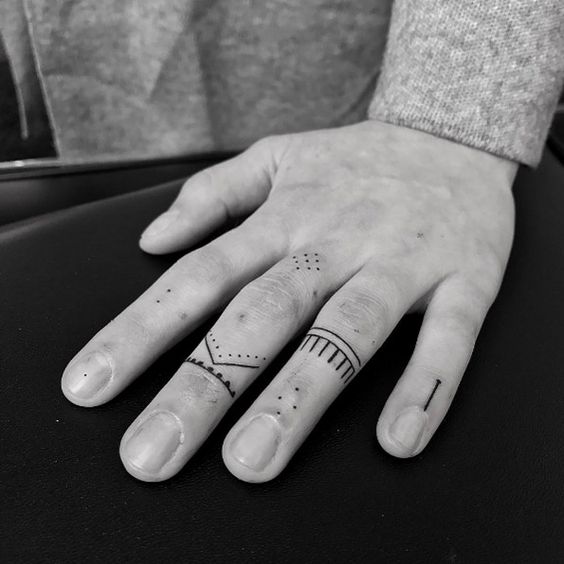 Subtle finger tattoos by Oliver Whiting