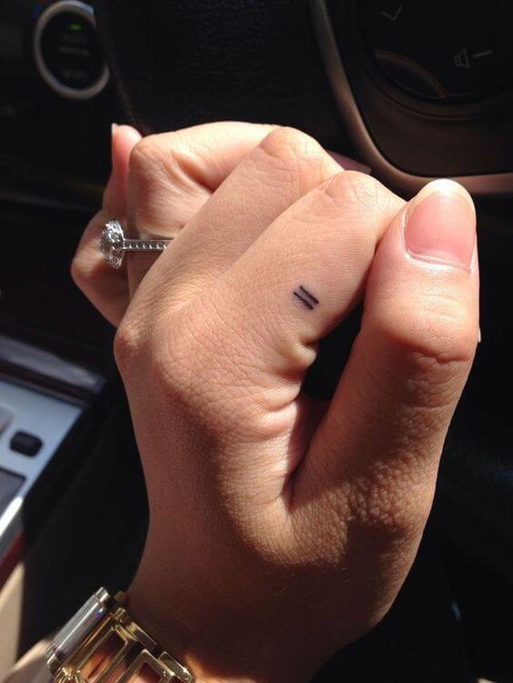 Tiny equal sign tattoo on the finger