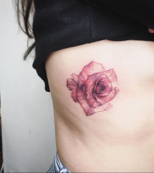 Watercolor rose tattoo on the rib cage by Tattooist Flower