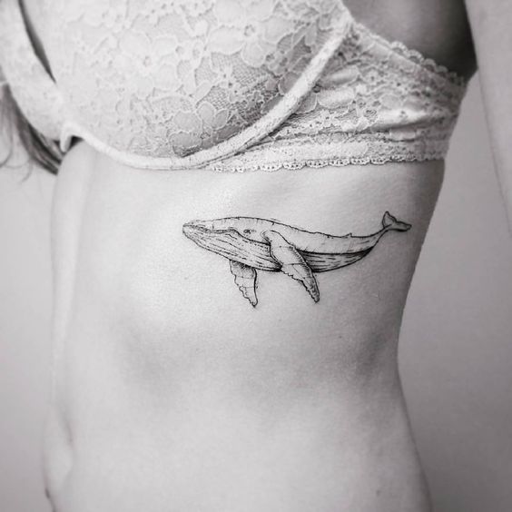 Whale tattoo on the left ribcage