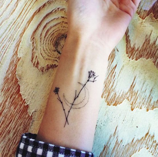 Wild flowers and crescent moon tattoo on the wrist