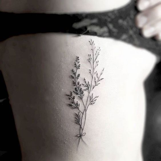 Wildflower tattoo on the rib
