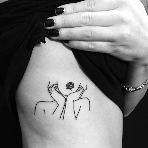 Woman tattoo on the rib