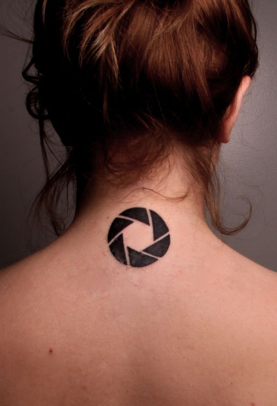 Aperture symbol tattoo on the back of the neck