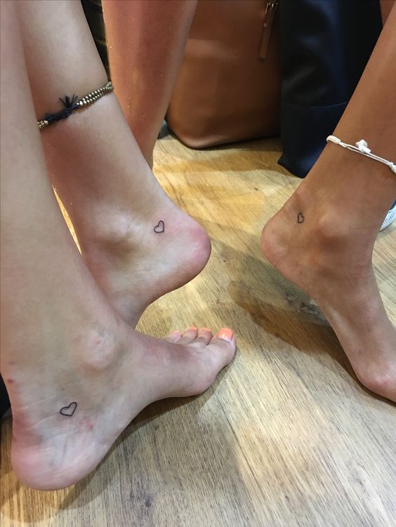 Best friends matching heart tattoo on ankles