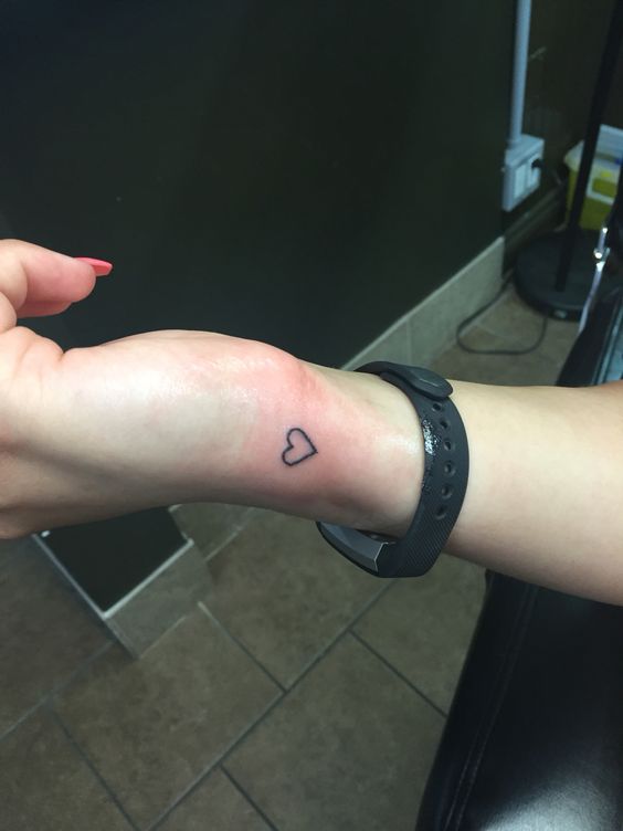 Black heart tattoo on the wrist