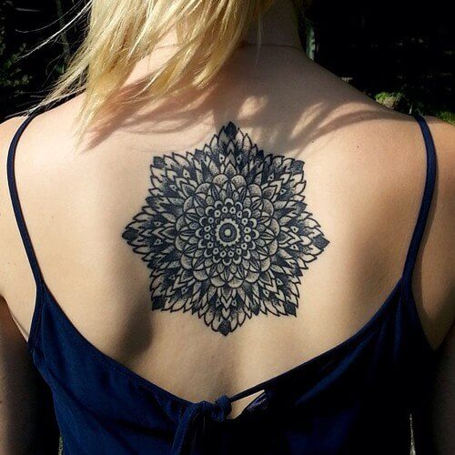 Black mandala tattoo on the back