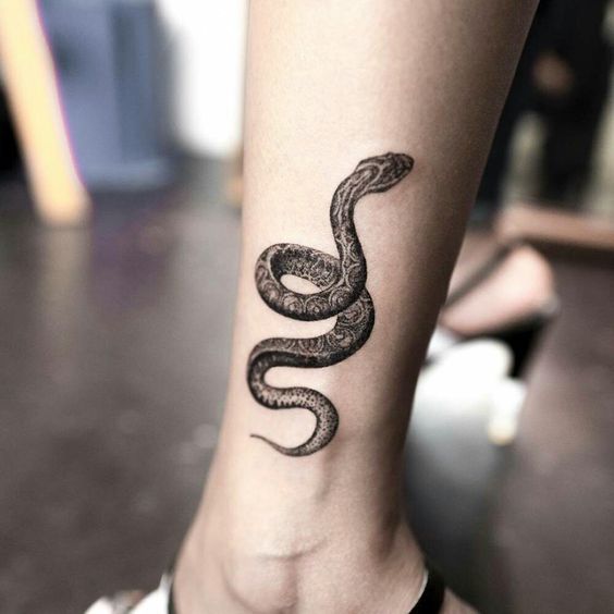 Black snake tattoo on the leg