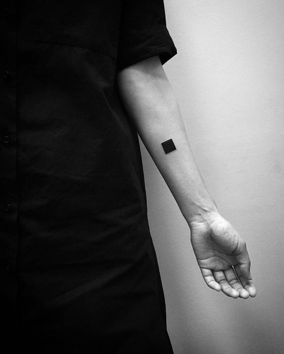 Black square tattoo on the arm