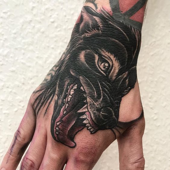 Black wolf tattoo on the hand