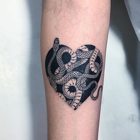 Blackwork snake tattoo in the heart