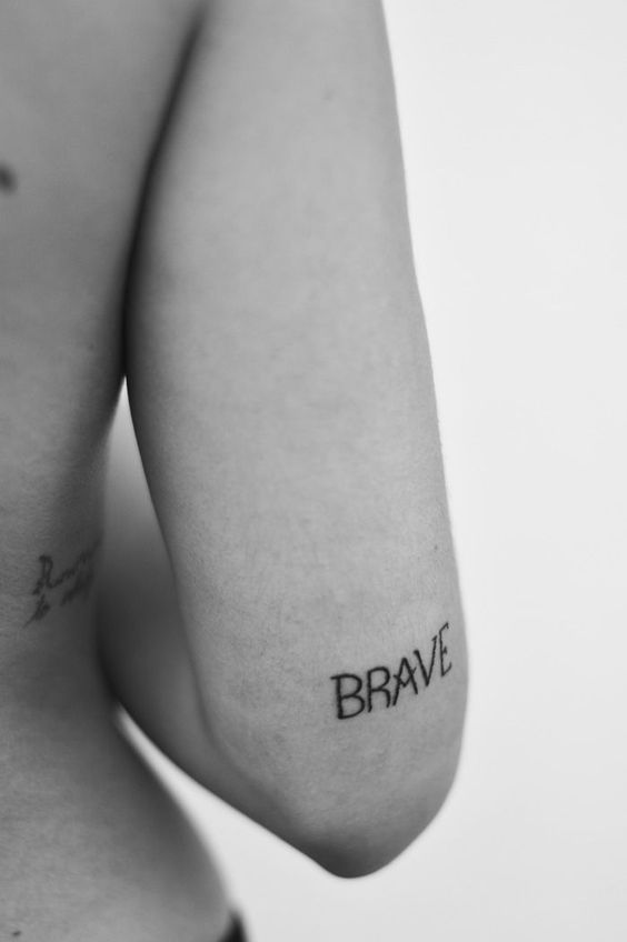 Brave tattoo on the back of the right arm