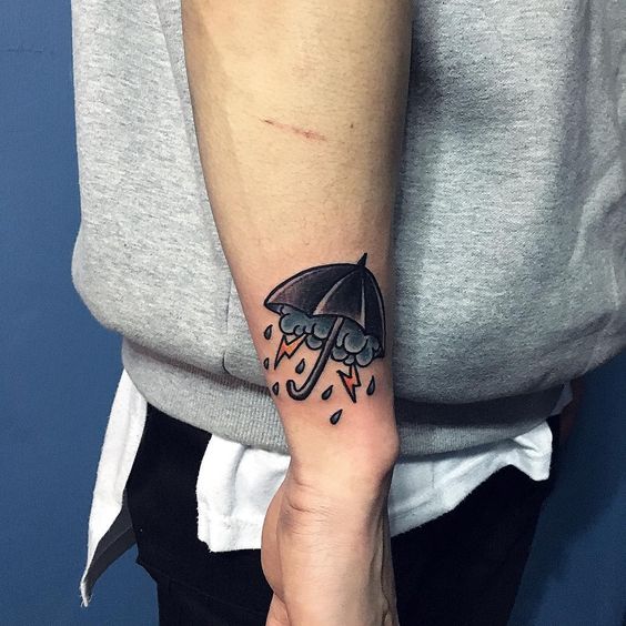 Classy umbrella tattoo on the arm