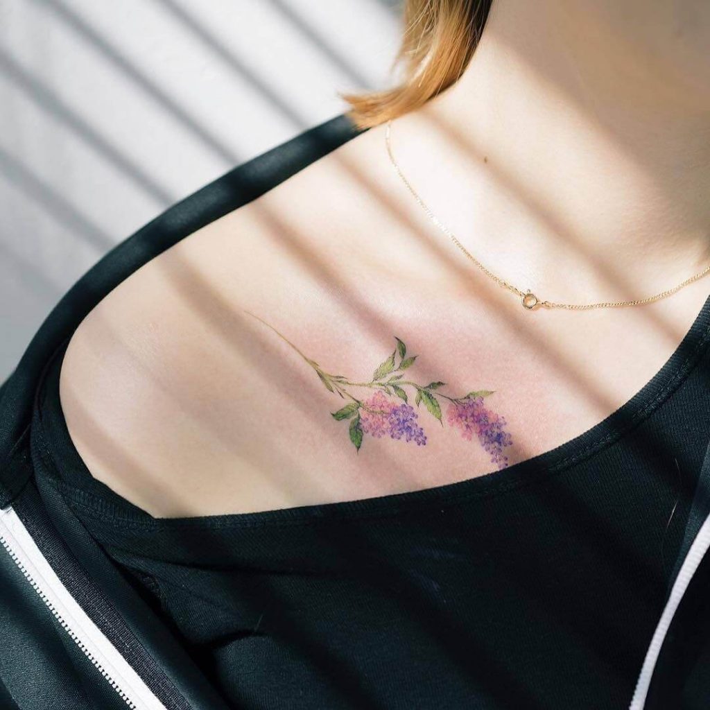 Colorful floral tattoo on the collarbone