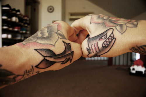 Cool matching shark tattoo on thumbs