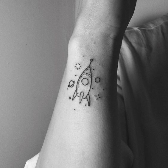 Cute spaceship tattoo on the wrist