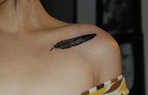 Feather tattoo on the clavicle bone