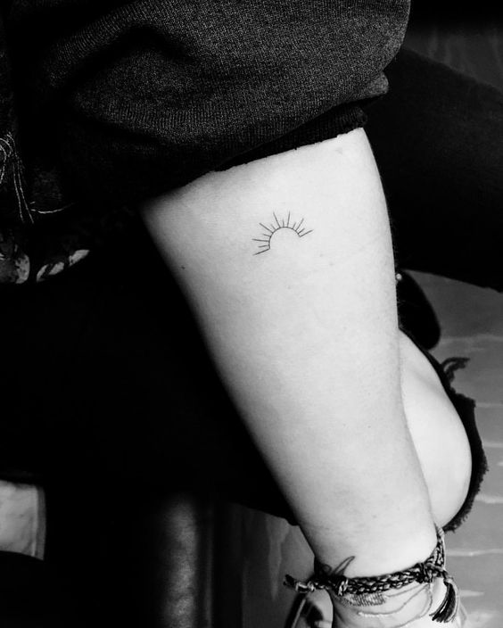 Here comes the sun minimal tattoo on the inner arm