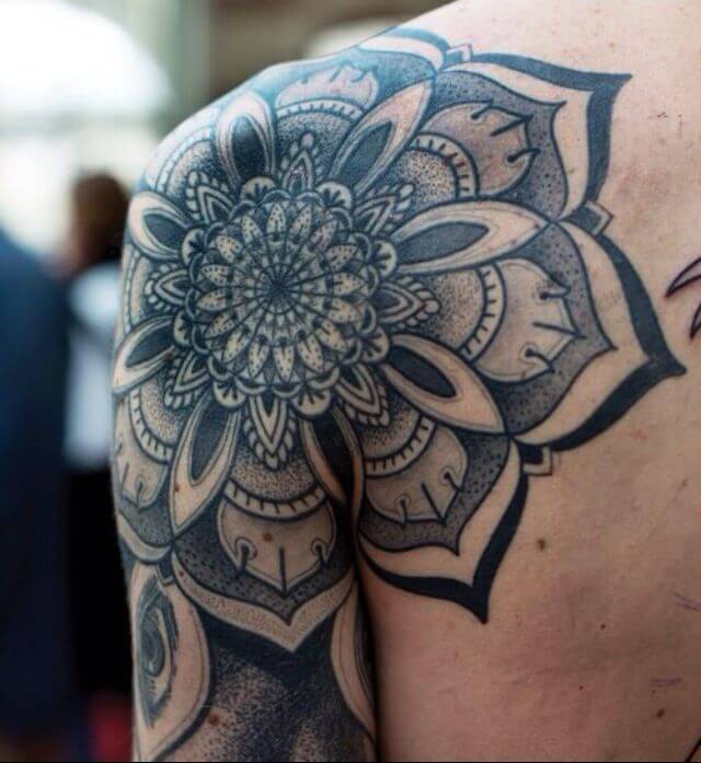 Huge black mandala tattoo on the shoulder