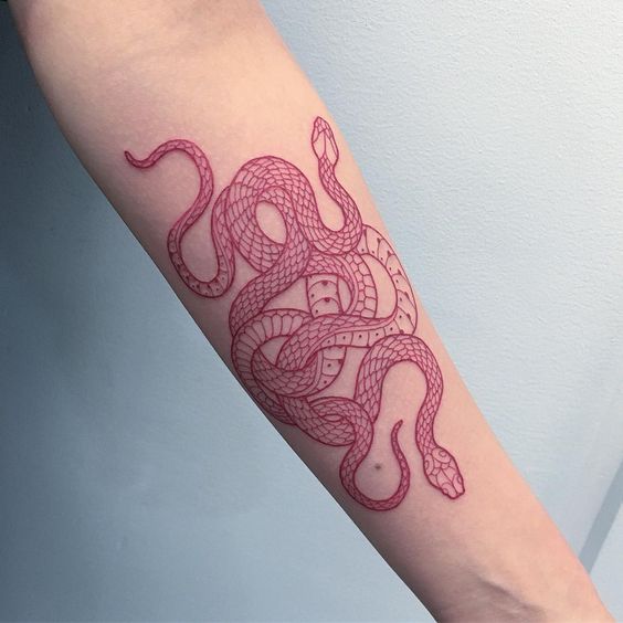 Intertwined red snake tattoo on the inner arm