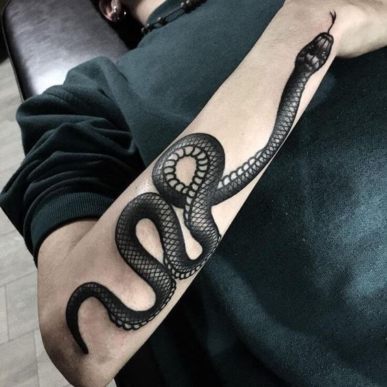 Large snake tattoo on the forearm