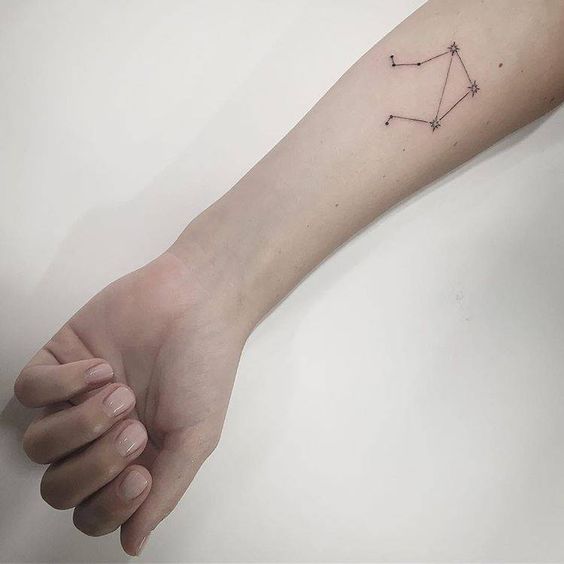 Libra constellation tattoo on the forearm