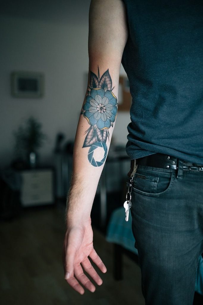 Mandala and aperture tattoo on the inner arm