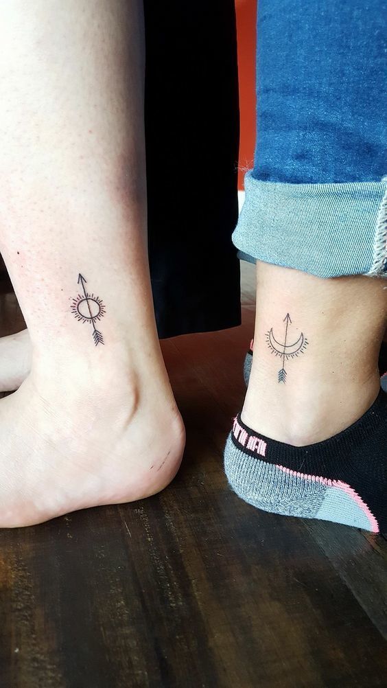 Matching sun and moon tattoos with arrows