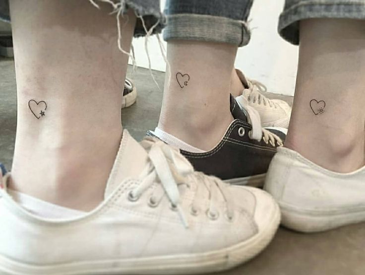 Matching three best friends small heart tattoos on the ankles